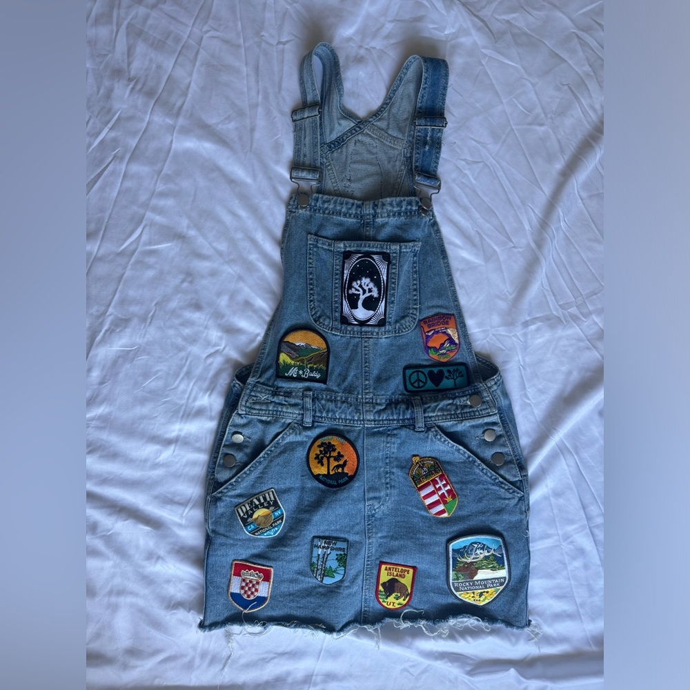 Patched denim overall skirt in size small.